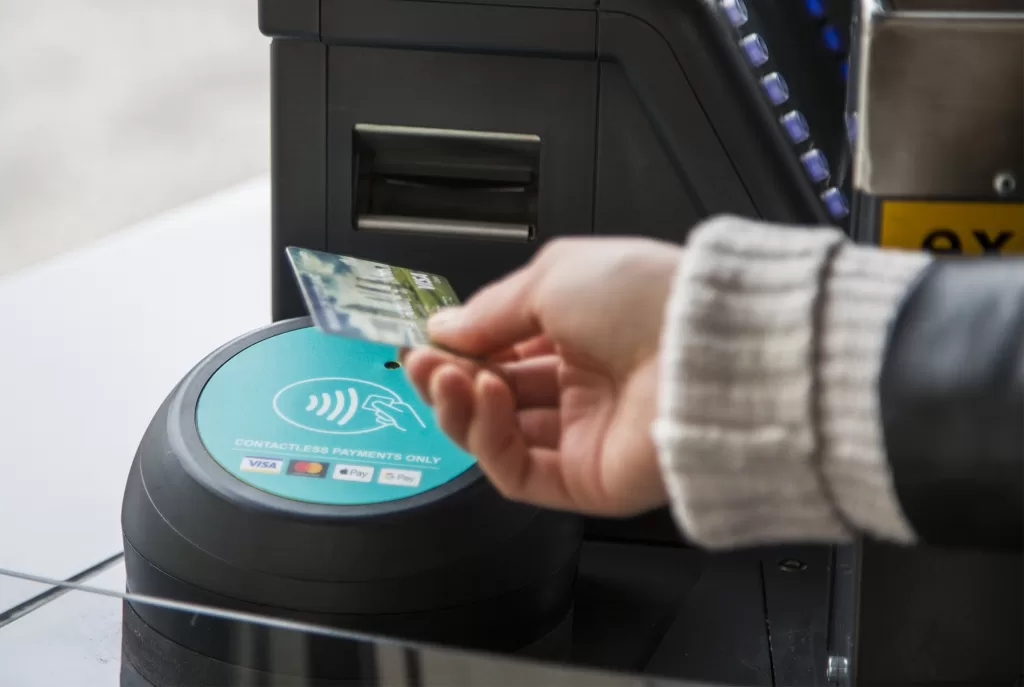 Contactless reader on a bus being tapped by a contactless credit card