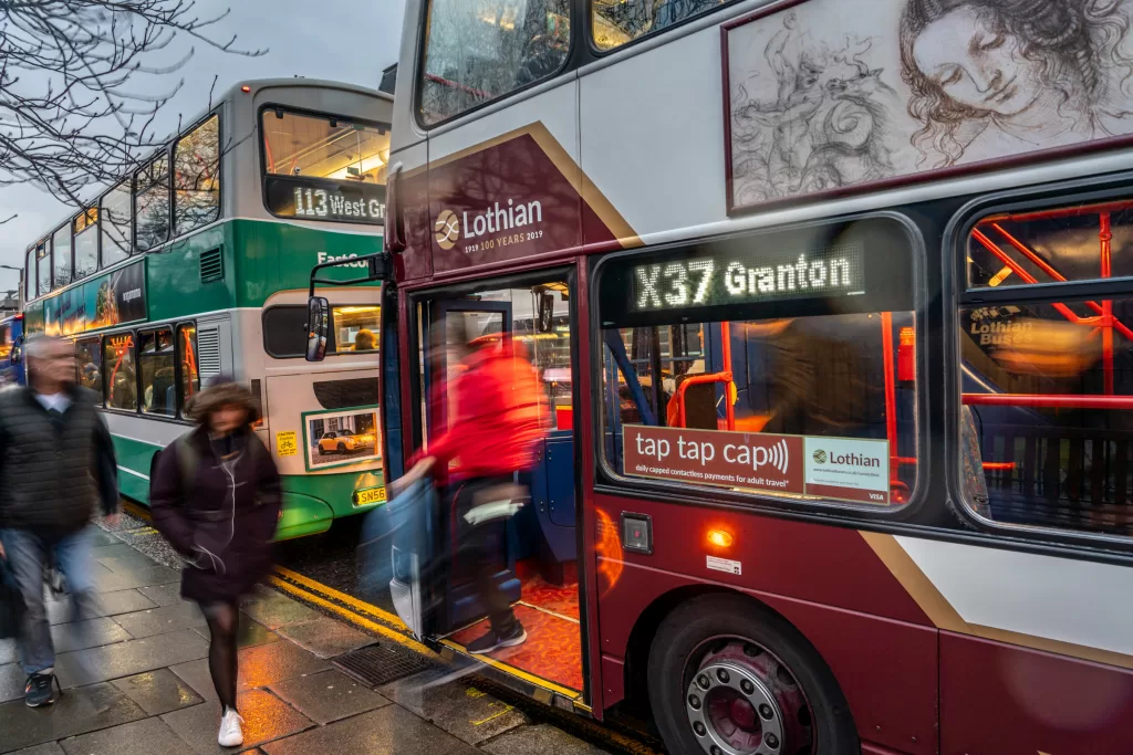 Lothian bus with advert in window promoting TapTapCap, its open loop fare collection system